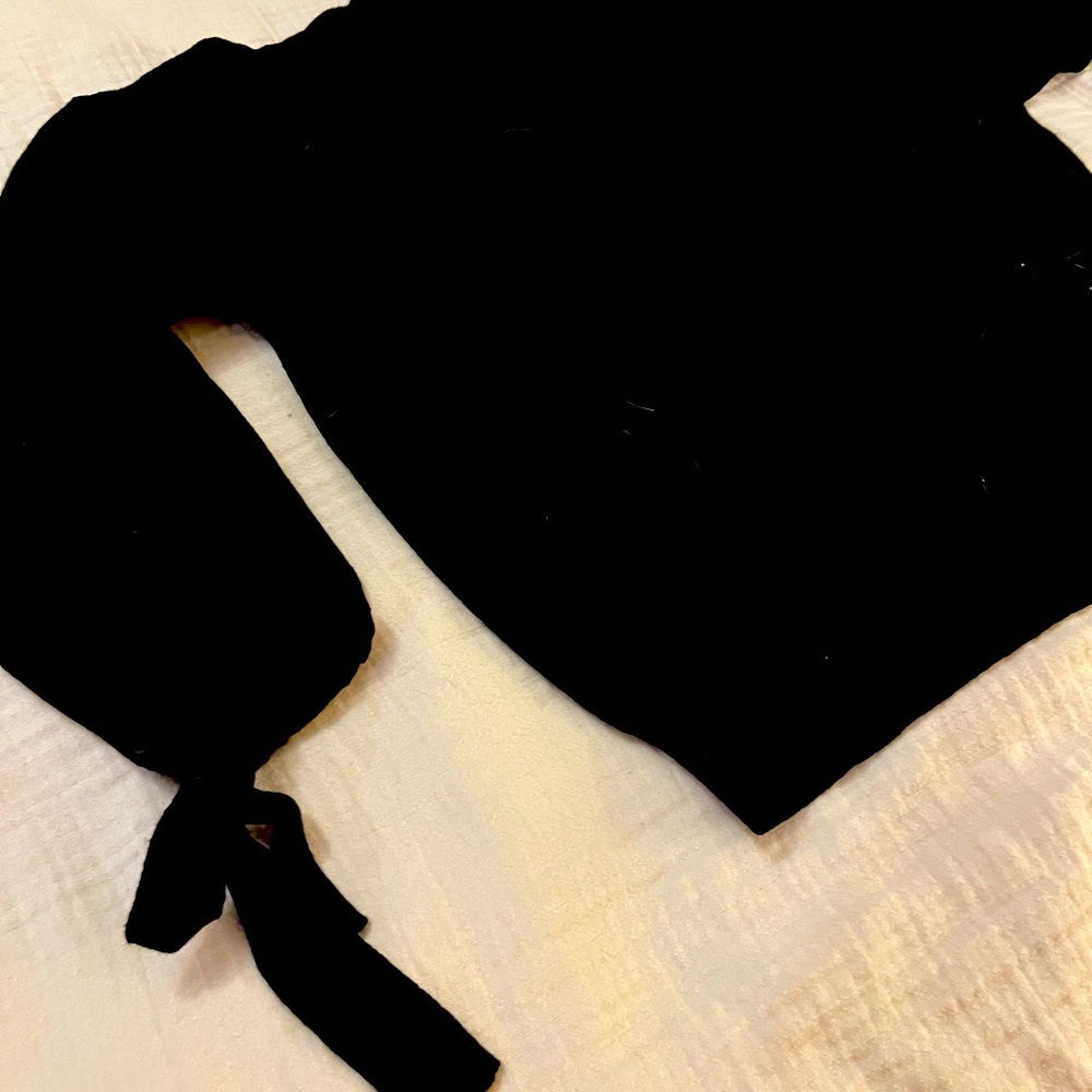 Women’s black sweater with arm detail